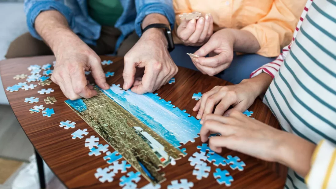 Assembling a puzzle together as a drug cravings and support idea. 